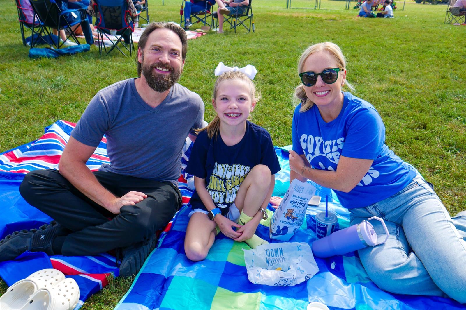 family sitting on a blanket